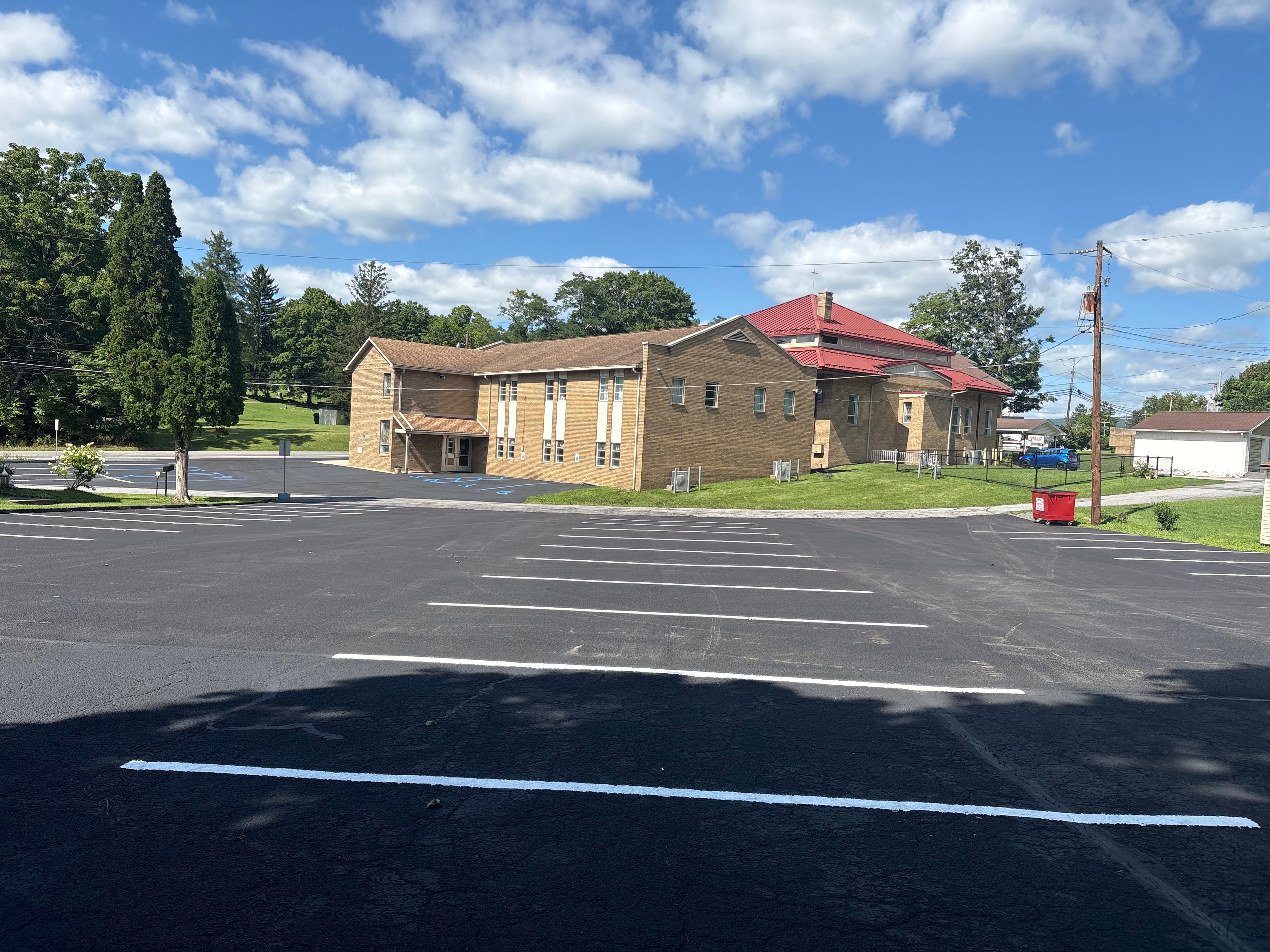 Church parking lot freshly paved and line-striped with white and blue markings