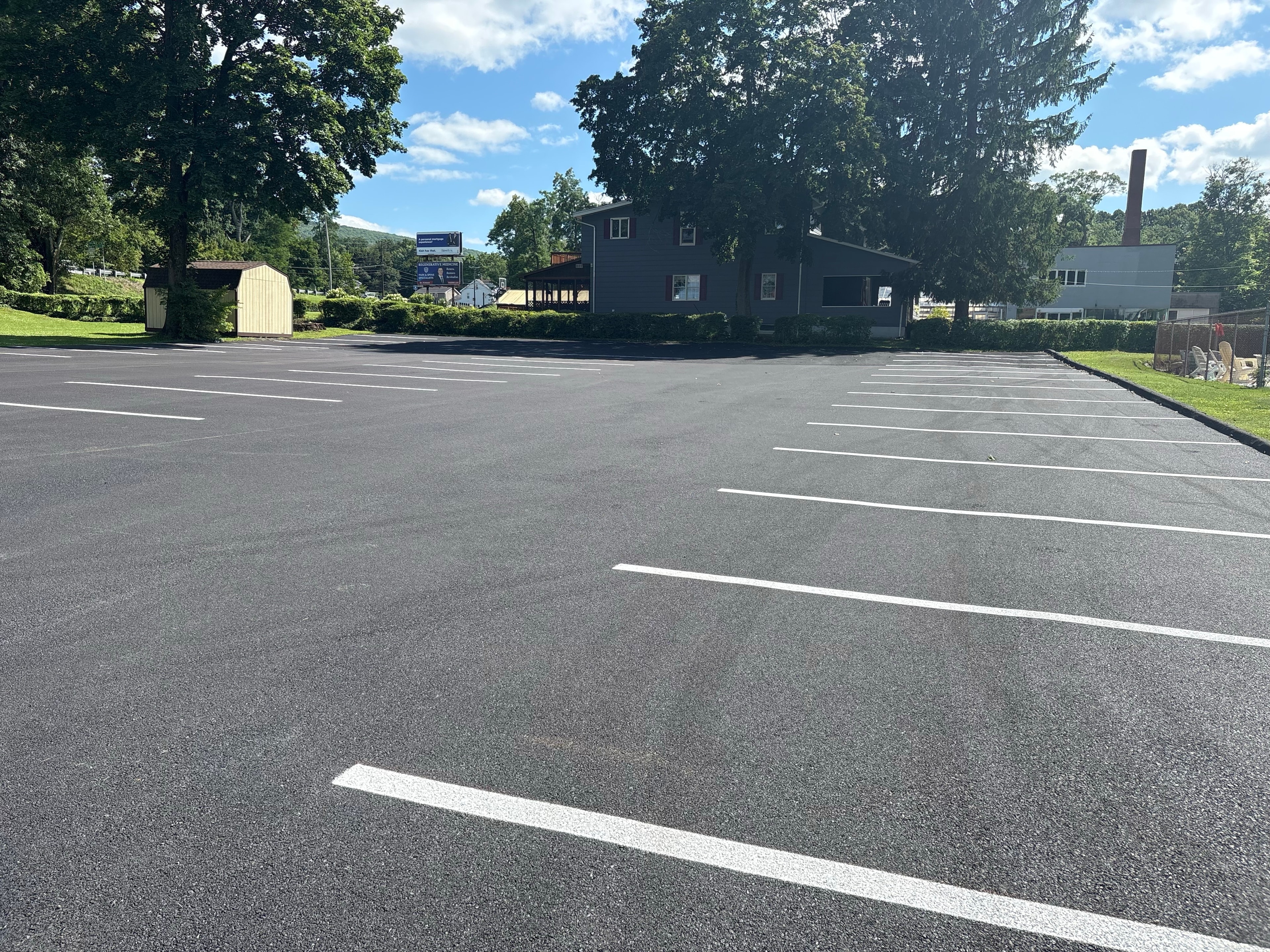 Freshly sealed and striped commercial parking lot at rural business