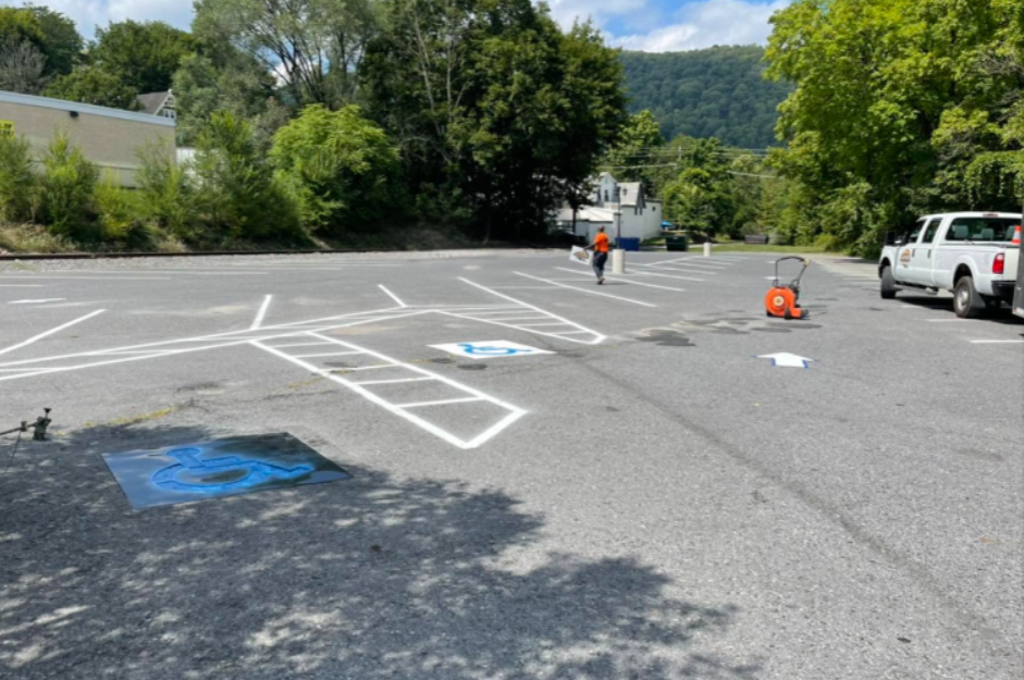 Parking lot line striping with handicap symbols and white markings