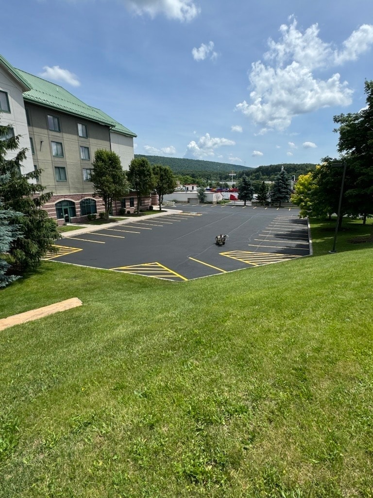 Hotel parking lot freshly sealed and line-striped with mountain backdrop