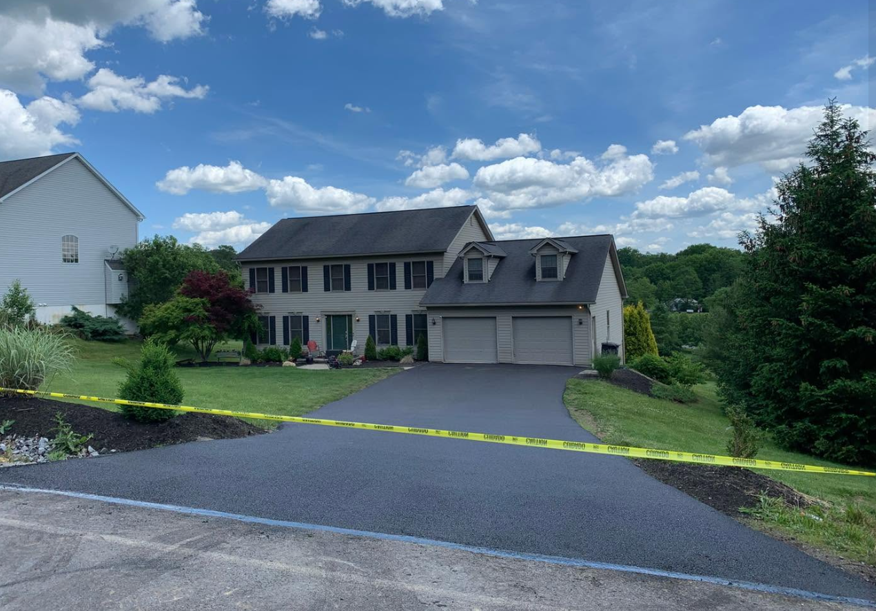 Suburban house with caution tape driveway