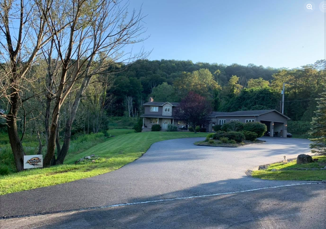 Residential home driveway surrounded by trees