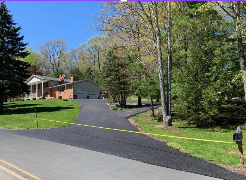 Brick house driveway wooded property