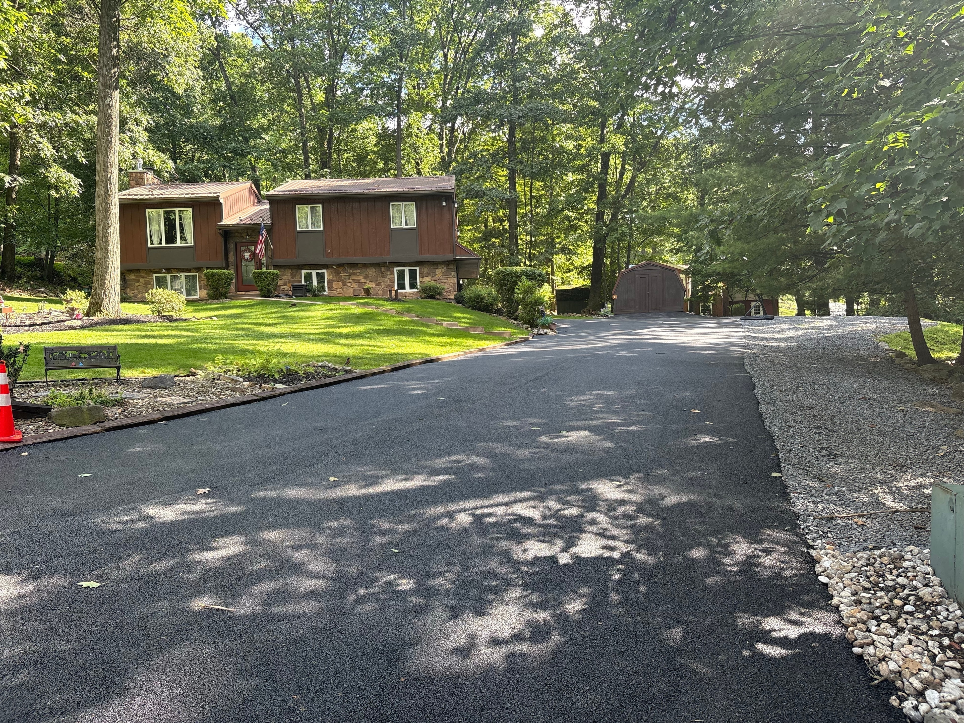 Modern split-level home wooded driveway