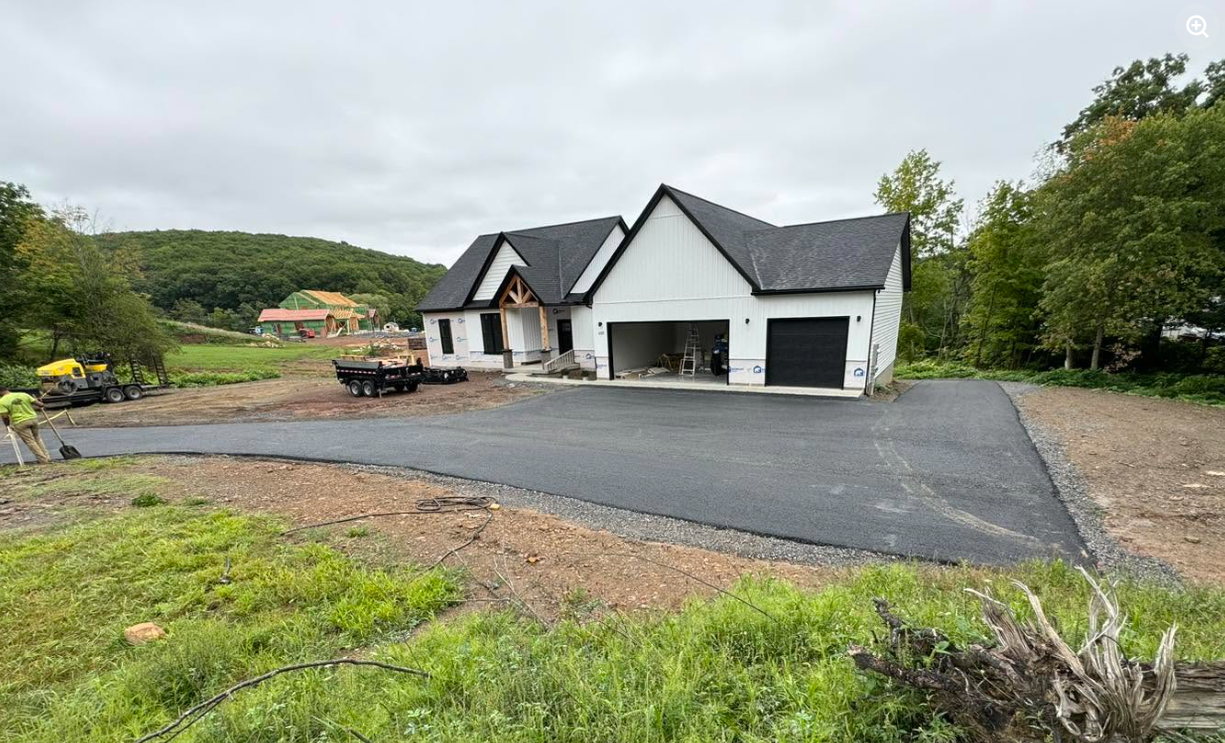 Modern white house with new asphalt driveway