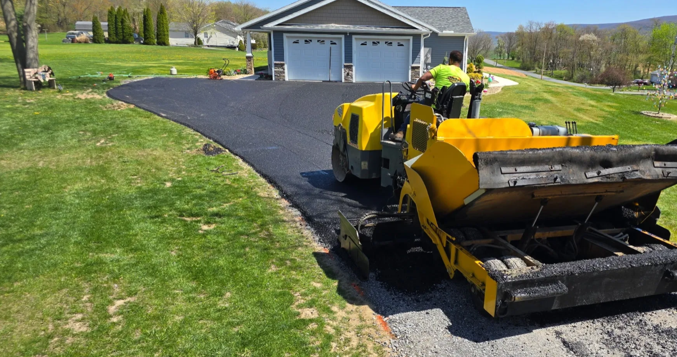 Rural property with winding new asphalt driveway and creek