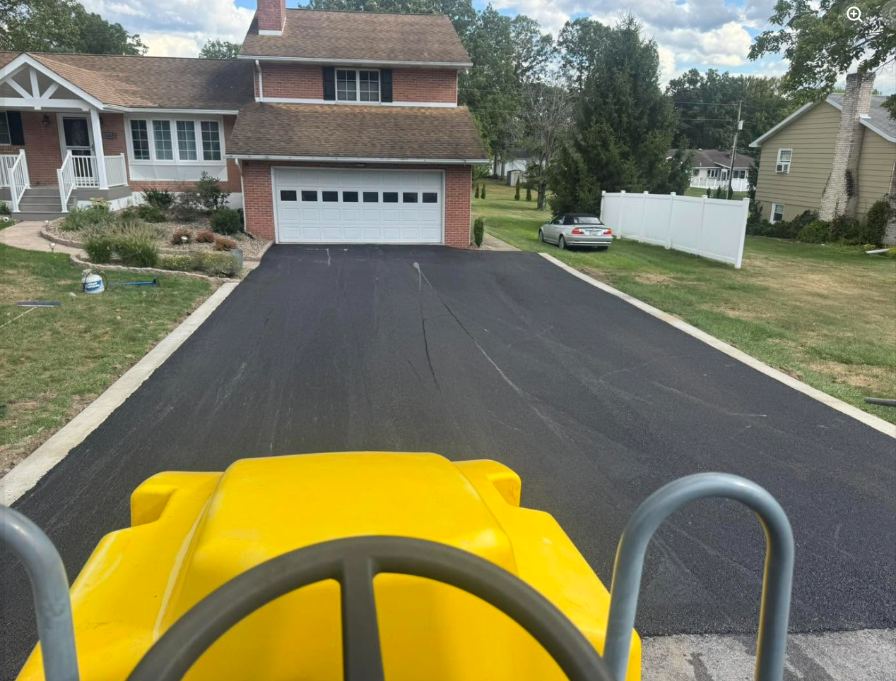 Worker finishing smooth concrete patio surface