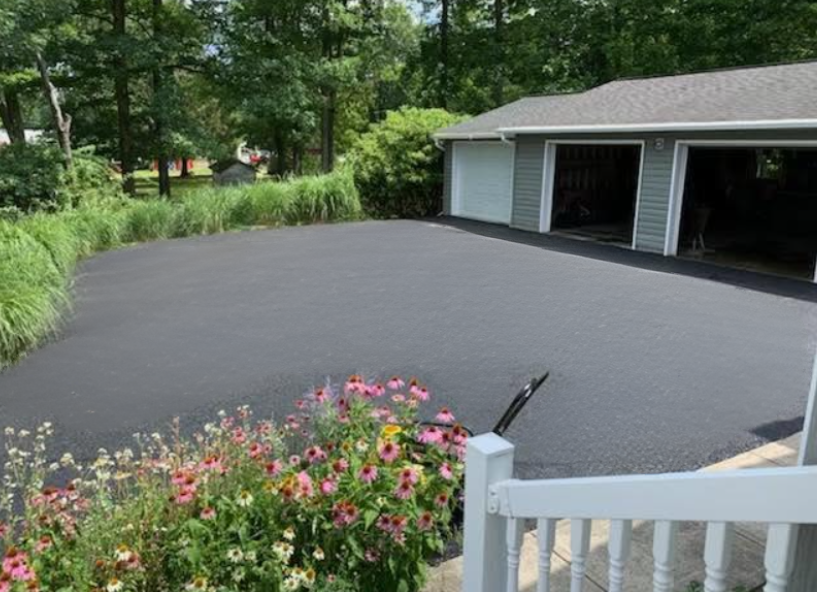 Residential driveway with garage and landscaping