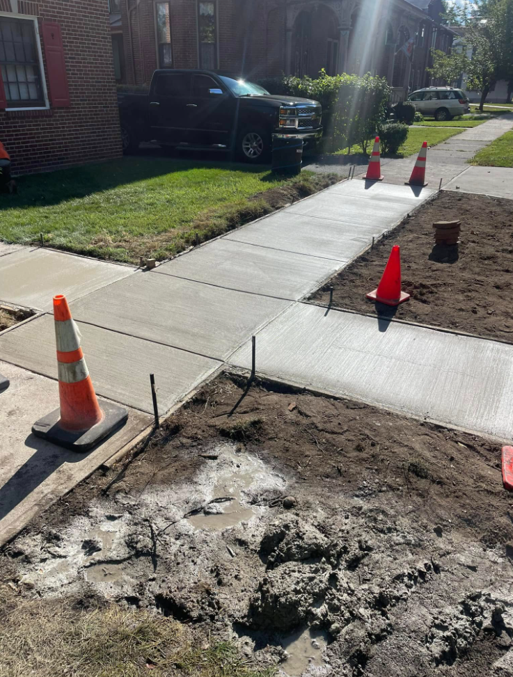Newly paved driveway at split-level home with CAT equipment